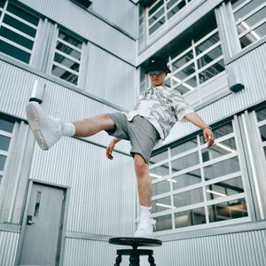 Man holding a difficult balance pose on one leg.