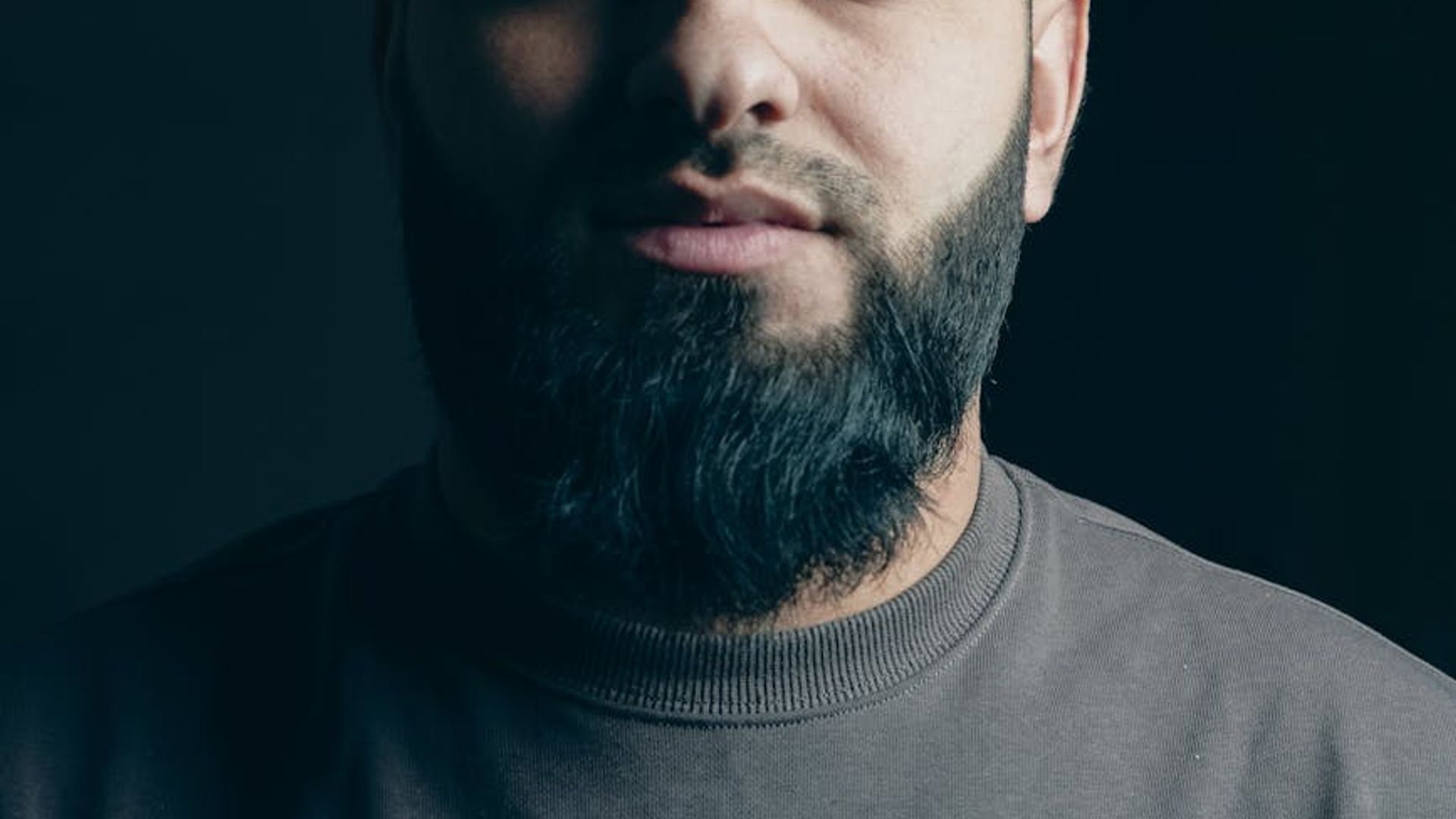 Silhouette of a man in a power stance against a dark background.